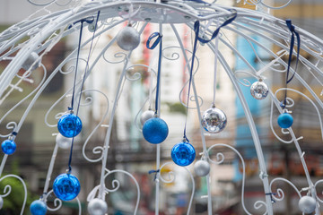Christmas balls hanging on ribbon with bokeh
