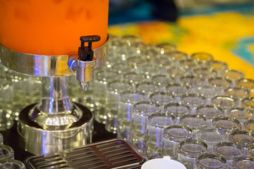 Many glasses with  orange juice on buffet table