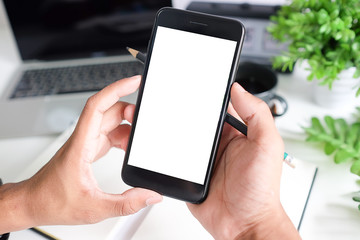 Cropped shot view of man hands holding smart phone with blank copy space screen for your text message or information content, female reading text message on cell telephone during in urban setting. 