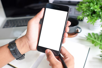 Cropped shot view of man hands holding smart phone with blank copy space screen for your text message or information content, female reading text message on cell telephone during in urban setting. 