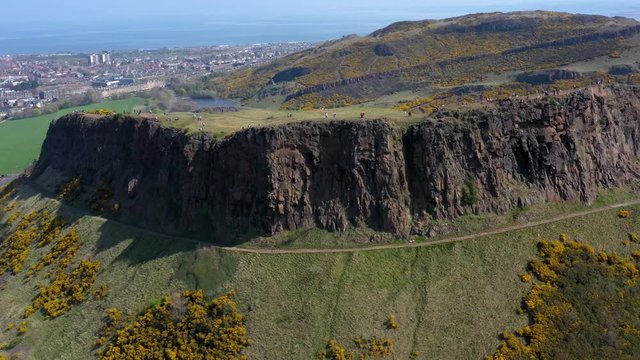 Panning Around The Crags at Arthur's Seat, near Holyrood Parliament, with Tourists Walking | Edinburgh, Scotland | 4K at 30 fps