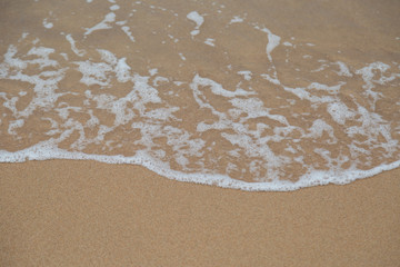 Fototapeta na wymiar Beach sand and ocean waves