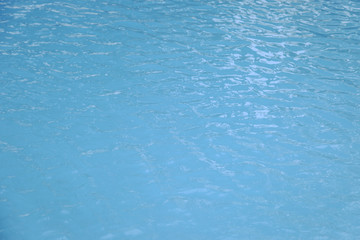 Blue swimming pool edge with refection of water ripple