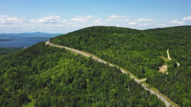 Aerial flight following road scenic destination Rangeley Lake