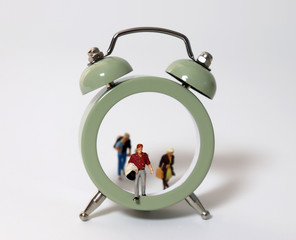 Miniature people walking out of the clock. 
