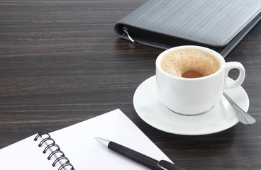 cup of coffee and pen on the table