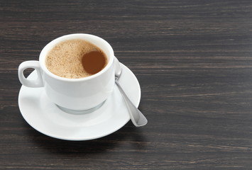 cup of coffee on wooden table