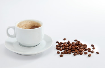 cup of coffee with beans on white background