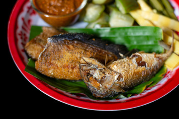Deep fried mackerel in a vegetable dish.
