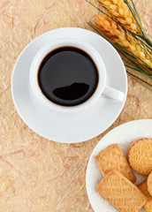cup of coffee and cookies on wooden table