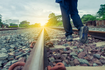 Pathway to success concept a man walk on the railroad go to the light at the destination with space area for write some text on background meaning walk to success concept