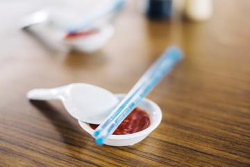 Asian garlic chili sauce in dish with soup spoons and chopsticks in Penang, Malaysia