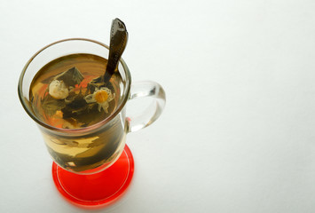 Tea with herbs on a white background. Herbal tea with mint and chamomile on a white surface. The concept of treatment and health.