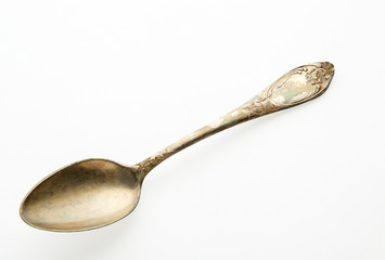 Spoon on isolate. Old empty spoon of an isolated surface.