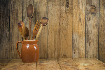 Vintage wooden background with wooden kitchen utensils