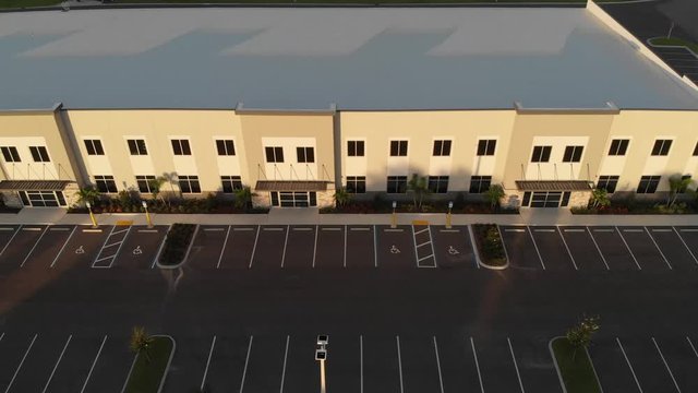 Aerial of newly constructed modern offices, light industrial, business facilities designed with white roofing