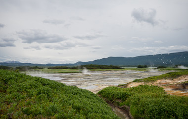 Panorama of hot springs, boiling mud pools and warm toxic lakes in Uzon caldera. Kronotsky Nature Reserve in Russian far east, Kamchatka peninsula. Protected environment . Access by helicopter only.