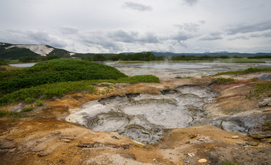 Panorama of hot springs, boiling mud pools and warm toxic lakes in Uzon caldera. Kronotsky Nature Reserve in Russian far east, Kamchatka peninsula. Protected environment . Access by helicopter only.