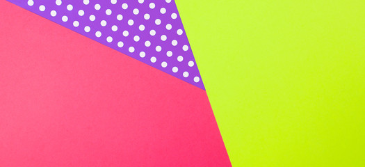 Abstract geometric yellow, purple and pink polka dot paper background.
