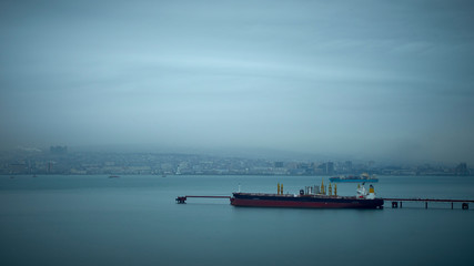 Image of a tanker loading oil on an oil terminal.