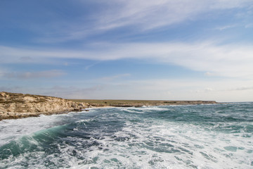 Sea waves crashing against the rocks. Day