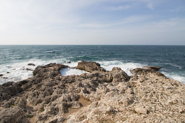 Sea waves crashing against the rocks. Day