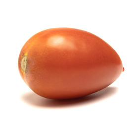  red and ripe tomato lies on a white background