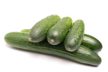 green cucumbers lie on a white background