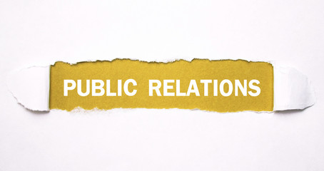 Text Public Relations on torn paper.
