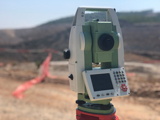 Geodetic total station on the construction site against blurred background