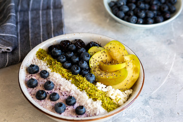 Breakfast in a bowl with berries and honey