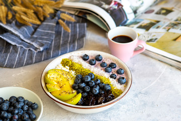 Breakfast in a bowl with berries and honey