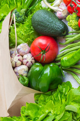 Healthy food in paper bag of different  vegetables on white background. Top view.