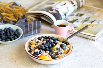 Breakfast in a bowl with berries and honey