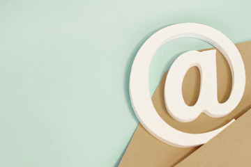 brown envelope with e-mail at sign on blue background