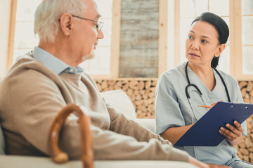 Attentive female with dark hair writing down indications