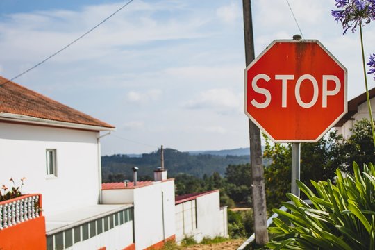 Stop sign with a beautiful background. Peaceful rural area view. Summer holidays feeling.