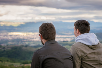Christian worship and praise. Two young man are praying and worshiping in the evening.