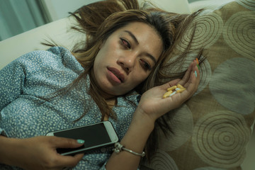young attractive depressed and helpless addict woman feeling desperate sad abusing tablets...