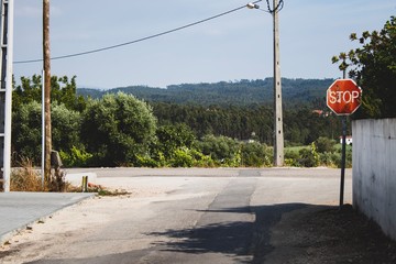 Stop sign with a beautiful background. Peaceful rural area view. Summer holidays feeling.