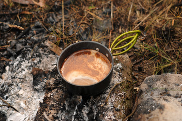 Aromatic and hot coffee on campfire