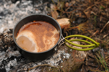 Aromatic and hot coffee on campfire
