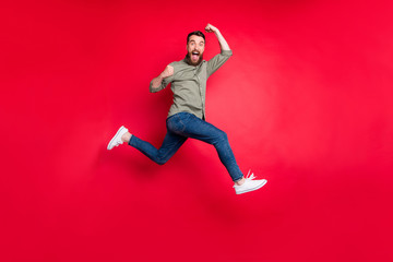 Full length body photo of bearded strong sporty handsome white man wearing grey t-shirt running...