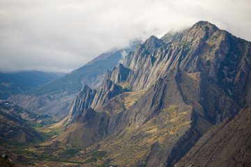 Image of picturesque mountain landscape with green vegetation, cloudy sky on summer