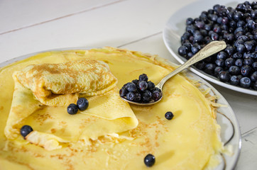 delicious, homemade pancakes with blueberries. Pancakes and berries in a plate on a white.
