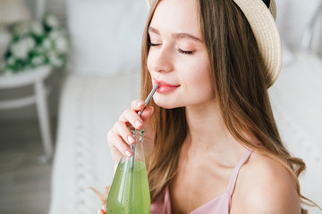 Girl drinks a healthy green drink with Basil seeds