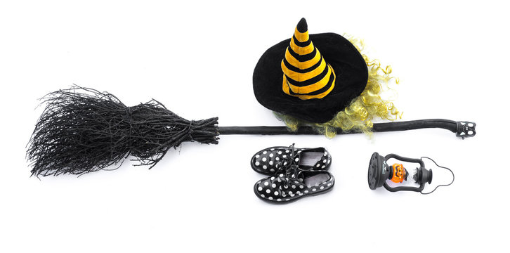 black halloween witch's broom and witch hat on a white background