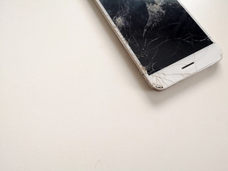 modern touch screen smartphone with broken screen on white background.