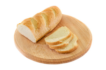 long loaf on a wooden board isolated on white background. Tasty Ukrainian bread