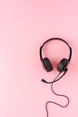Customer service headset on pink background. Call center concept